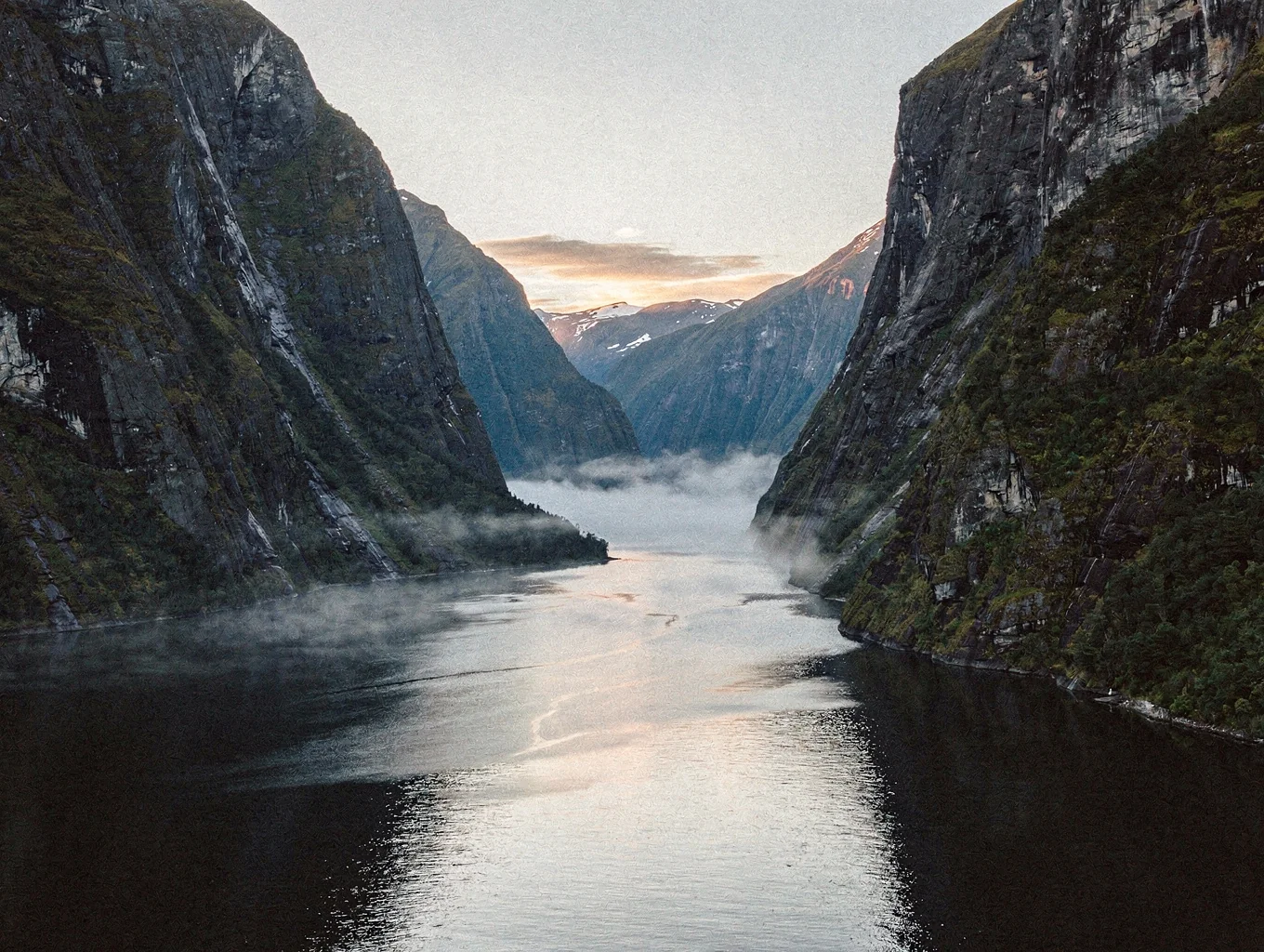 Fiordland mountain peaks shrouded in morning mist in New Zealand
